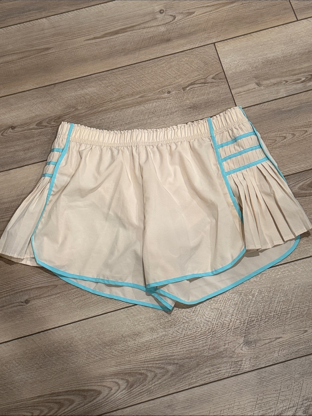 Cream Athletic Shorts with Aqua Trim and Pleated Side